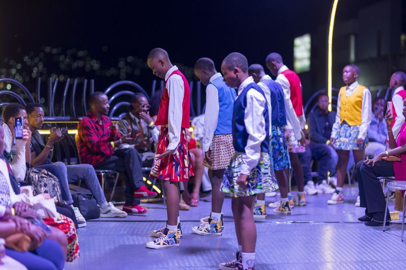 The crew performing on stage at a night event, audience watching.
