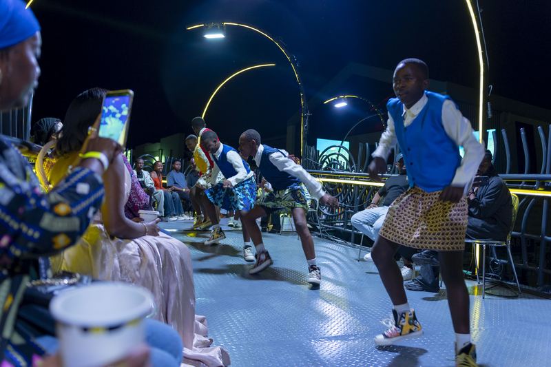 CCF dancers performing in kilts at a night event.